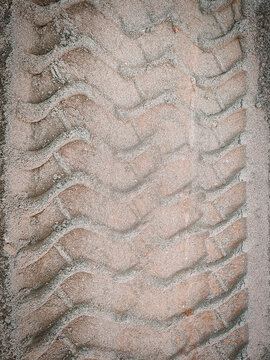 Heavy equipment tire track texture on sand background