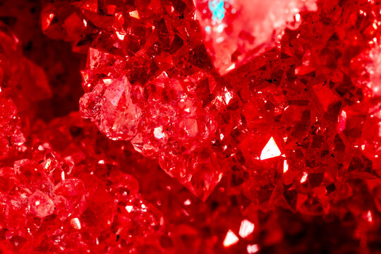 Amethyst red crystals. Gems. Mineral crystals in the natural environment. Texture of precious and semiprecious stones. Seamless background with copy space colored shiny surface of precious stones.