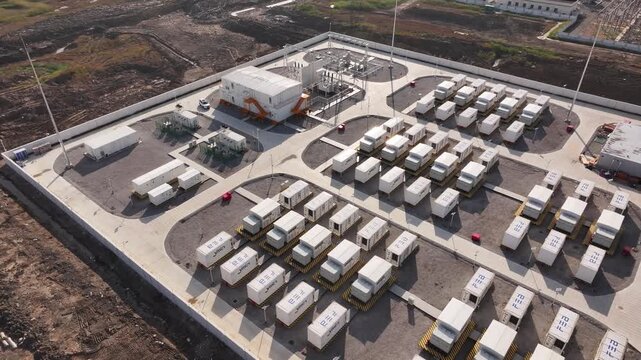 Aerial view of large-scale energy storage station with battery container arrays arranged in orderly rows