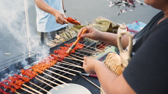Vendor Cooking Barbecue While Customer Orders at Street Market