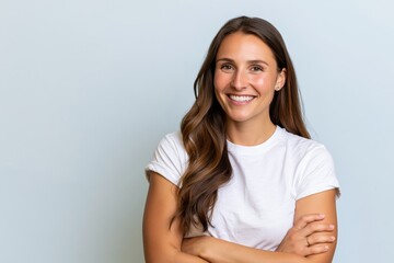 Fototapeta premium The Confident Smiling Woman Portrait in a White Tee Against Soft Blue Background