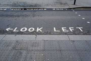 Fototapeta premium Look Left road safety marking at a pedestrian crossing in London