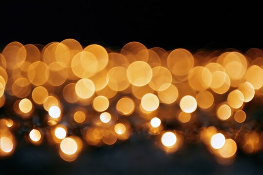 The Warm City Lights Bokeh Nightscape with Soft Glows and Floating Orbs
