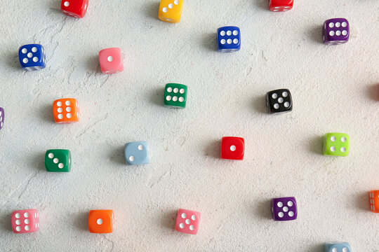Many colorful dices on light background