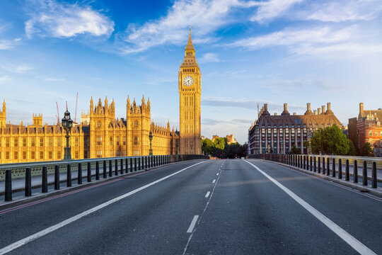Summer sunrise view of the Westminster Bridge with Big Ben clocktower in golden sunlight without people