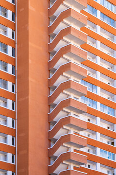 Orange apartment balconies repeat across a highrise facade in Benidorm, where residential architecture, windows and vertical exterior rhythm dominate