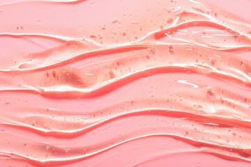 Texture of snail mucin gel on pink background © Pixel-Shot