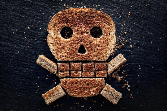 Toast with skull and crossbones concept for allergen care and gluten intolerance danger