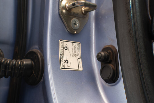 Vehicle door jamb with tire pressure information sticker displaying recommended tire specifications.