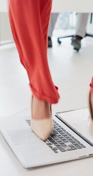 Angry, laptop and feet of business woman with mistake, anger and frustrated for slow internet. Stress, office and person with computer for damage, smash and rage for problem, crisis and disaster
