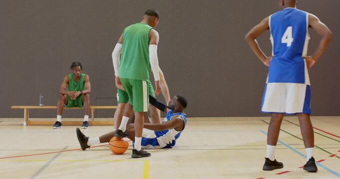 Diverse players executing basketball crossover meeting defender block falling helping on court