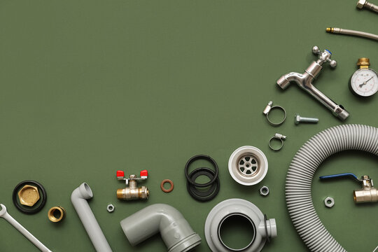 Set of plumbers items on green background