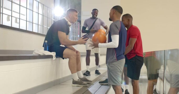 Checking smartphone in gym triggers diverse male friends and retrieving basketballs to play game