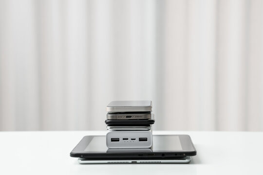 Stack on modern gadgets on light table indoors