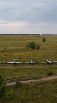 Abandoned trainer jet aircrafts Aero L-29 parked in line on neglected airfield
