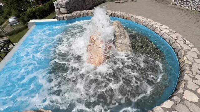 A powerful artesian spring gushing crystal-clear water, fully developed for public use.