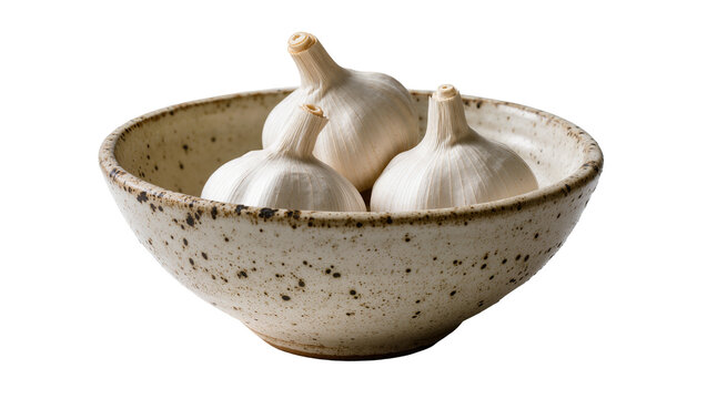 Three whole garlic bulbs in a speckled ceramic bowl, isolated on transparent background