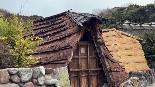 Architectural detail shot of a traditional Yunohana hut roof, showcasing artisanal bamboo and straw construction