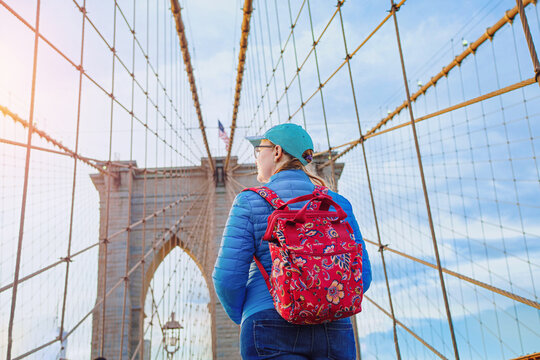  A female tourist in New York Brooklyn Bridge - big panorama.