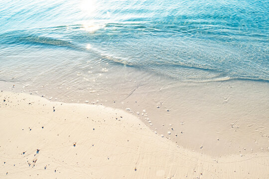 Summer morning seascape beautiful waves with sunlight reflection and tropical coral sand beach