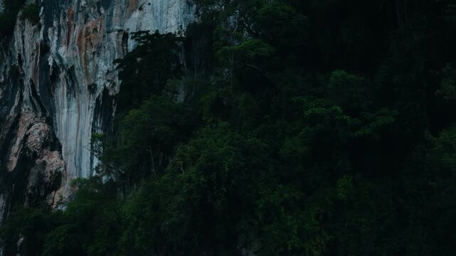 Khao sok national park lake view from boat in Thailand. Tracking shot of wooden boat bow gliding across mountain lake.