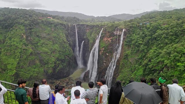 Indian people watching Jog Falls showcasing cascading water and scenic natural landscape in monsoon