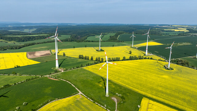 Aerial view of wind farm in rural rapeseed field of Germany