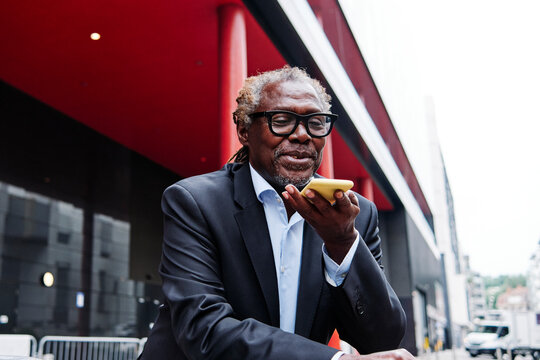 Senior male professional with eyeglasses talking on mobile phone