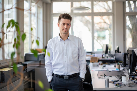 Confident manager standing in a bright modern office
