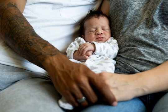Newborn baby between his parents