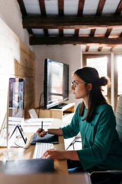 Female architect using computer at home