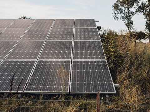 Solar panel array in a summer meadow in Tuscany