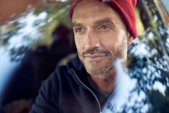 Portrait of bearded mature man behind windscreen