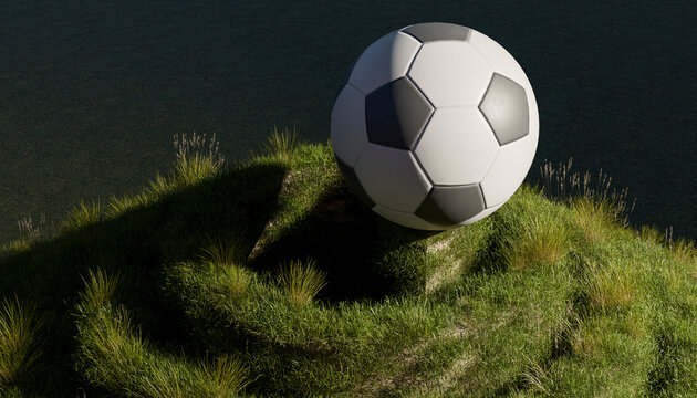 Large 3D soccer ball resting on a grassy green hill outdoor