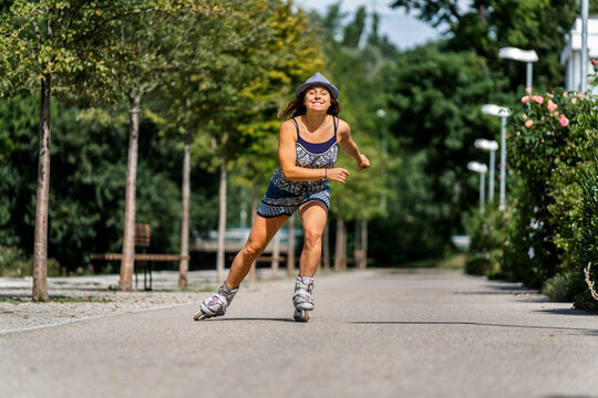Smiling young woman riding inline skates