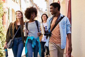 Fototapeta premium Diverse group of friends sightseeing in colorful city street