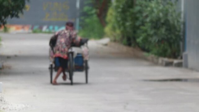 Pedicab Transportation On A Quiet Urban Street In Indonesia