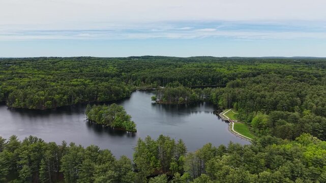Drone flight at Harold Parker State Forest, with an island and a peninsula on the lake, incredible view in Massachusetts, United States
