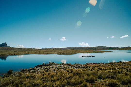 A serene lake in a mountainous landscape of the Peruvian Andes.