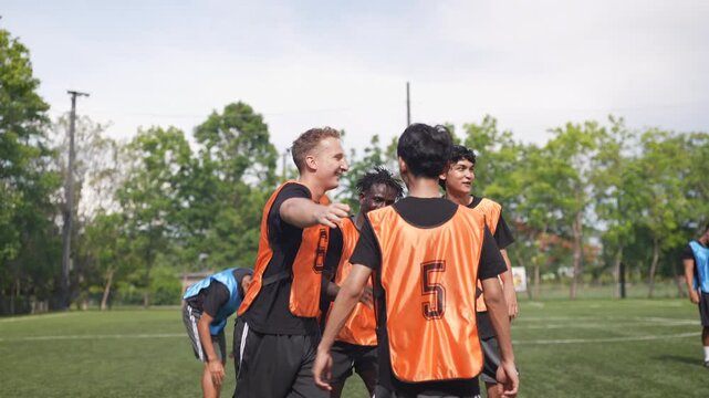 Youth soccer teams train and compete on an outdoor field under the supervision of experienced coaches and a referee. Young athletes develop technical skills, teamwork, sportsmanship, and determination