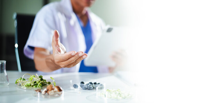 A professional researcher presents organic food samples in a modern lab. Ideal for nutritional science, food safety, agricultural research, and healthcare projects.