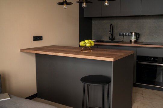 Contemporary domestic kitchen featuring sleek grey cupboards and an induction cooktop