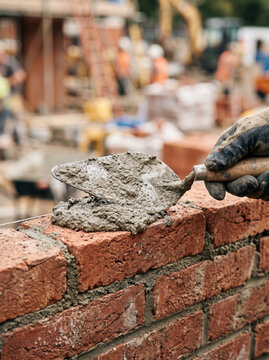 Bricklayer Worker Hand Applying Mortar Mix Using Industrial Trowel