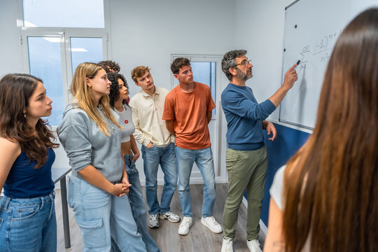 Teacher explaining mathematics to diverse students in classroom