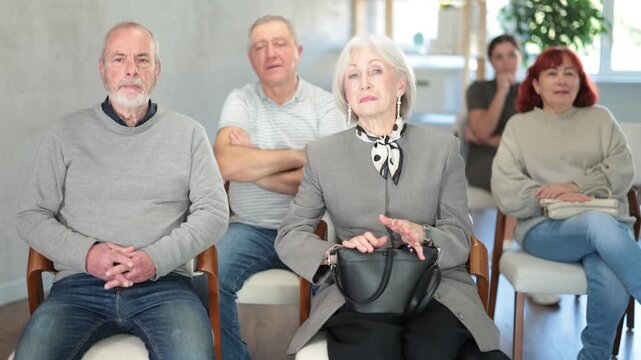 Elderly people are listening to lecture in auditorium. Group psychological interaction, practical classes in psychology. High quality 4k footage