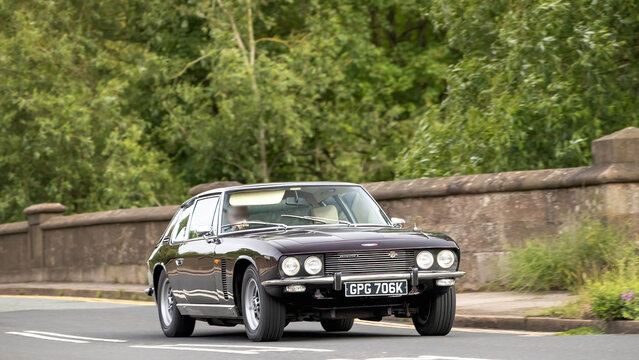 Stony Stratford,Bucks,UK - June 7th 2026: 1971 Jensen Interceptor   classic car driving on a British road