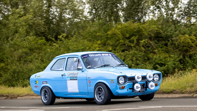 Stony Stratford,Bucks,UK - June 7th 2026: 1973 blue Ford Escort  Mk1 rally car driving on a British road