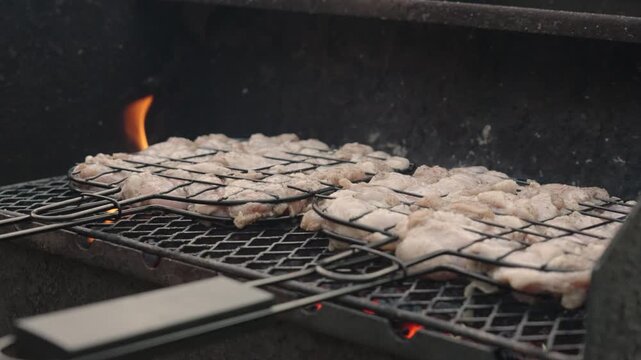 Fresh marinated meat grilling over hot charcoal and open flame