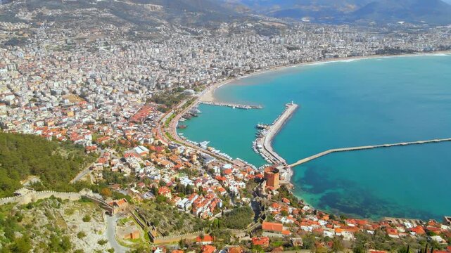 Aerial drone panoramic view of Alanya city harbor and famous Kizil Kule tower landscape.