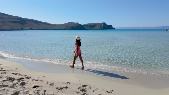 Feel the soft sand beneath your feet as you walk along the serene shores of Simos Beach. The crystal-clear waters glisten in the warm sun, creating a perfect escape in Greece.